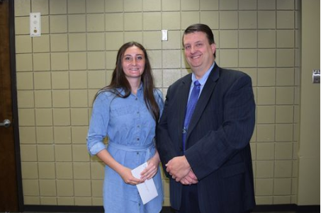 Scholarship recipient stands with Dr. Smith, Superintendent 